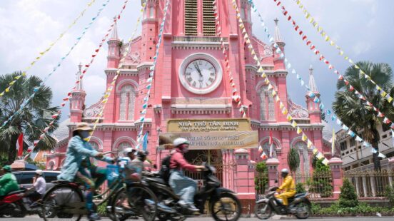 Pink Catholic Church and traffic in Ho Chi Minh City, Vietnam