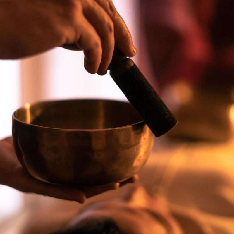 A sound bowl being used for a sound bath therapy