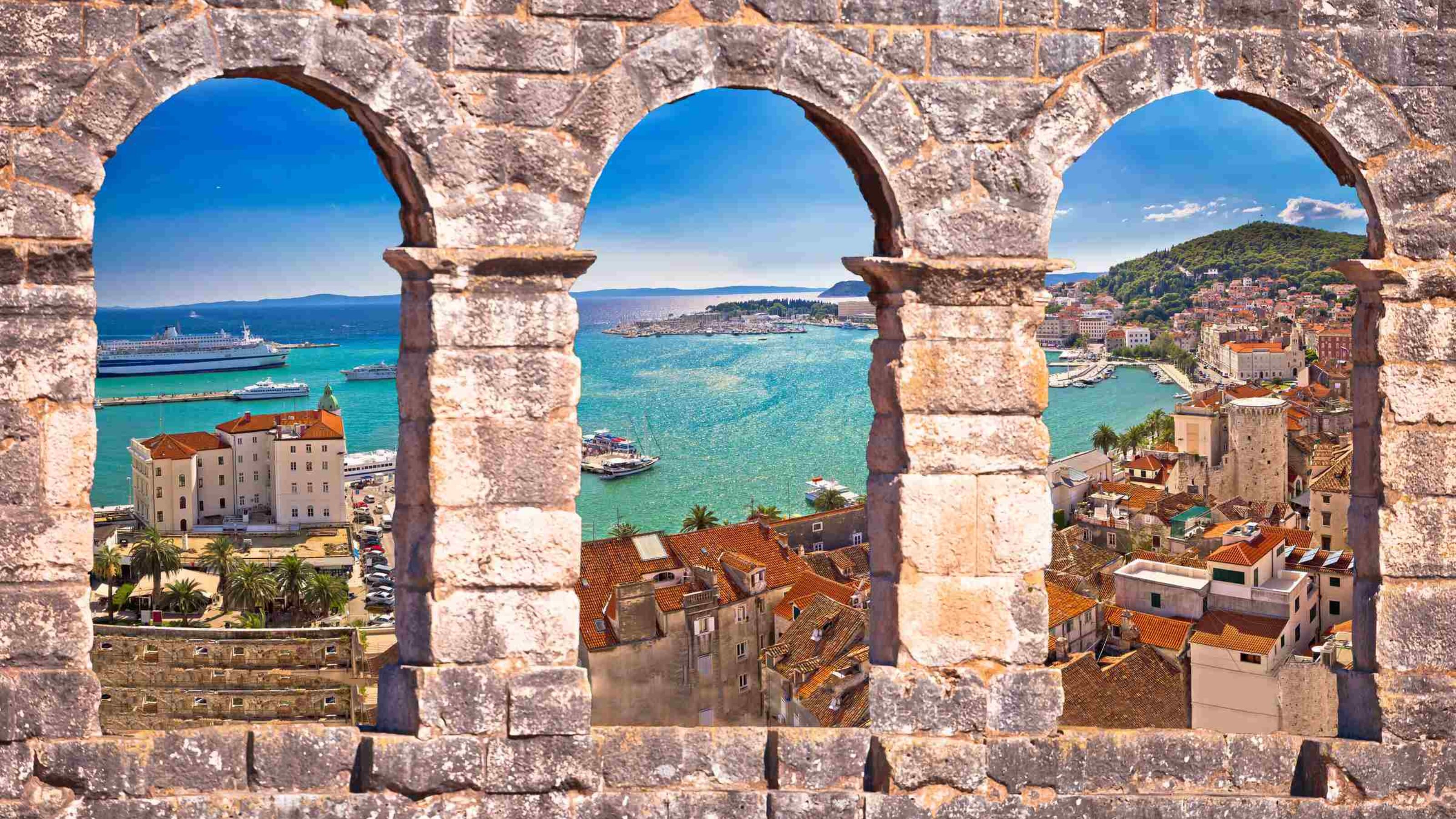 Panoramic view of Split from above through a stone window.