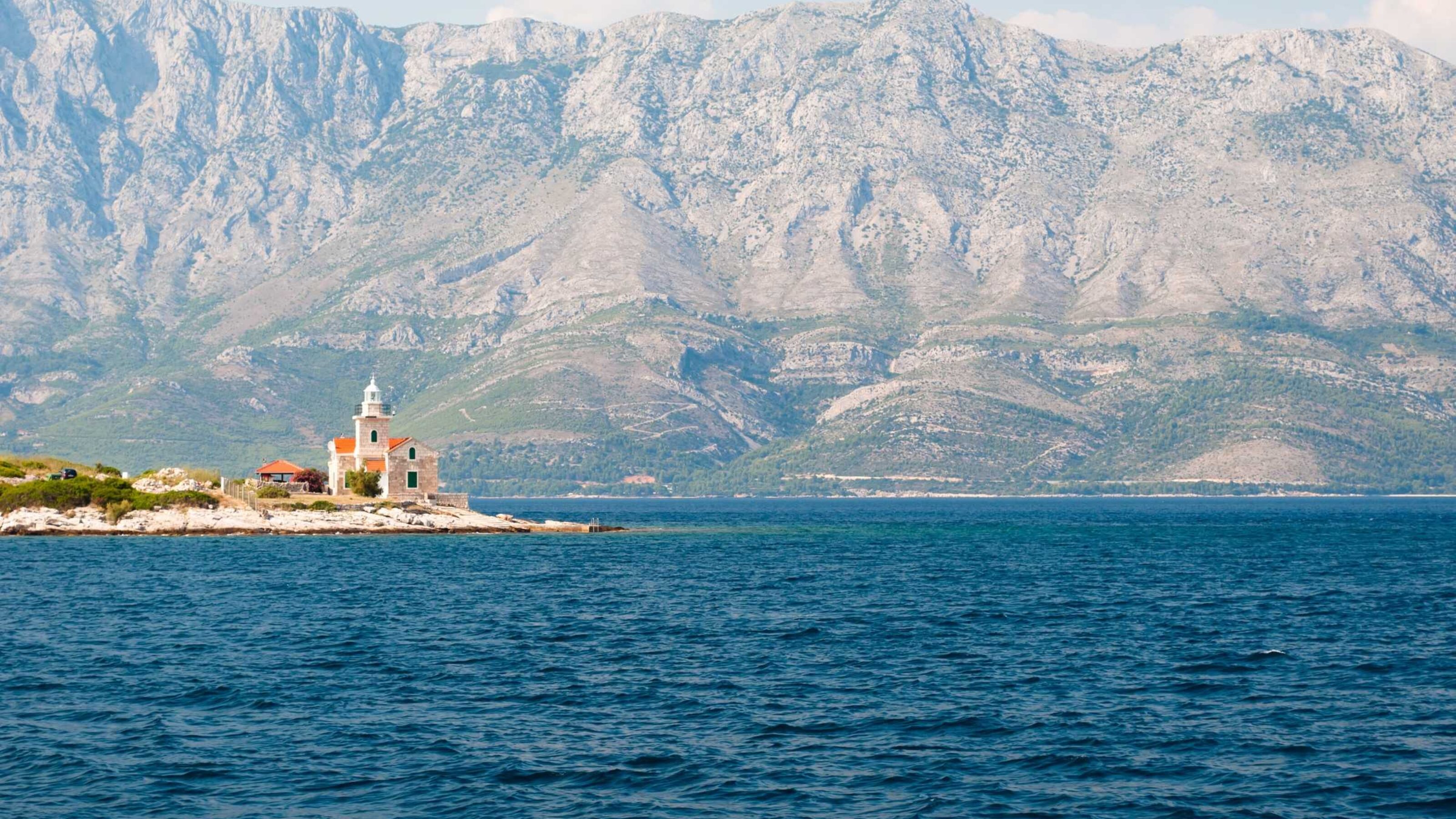 Lighthouse on south end of island Hvar with mountain Biokovo in the backdrop.
