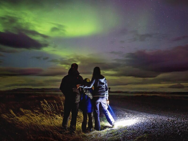 A family stood watching the northern lights