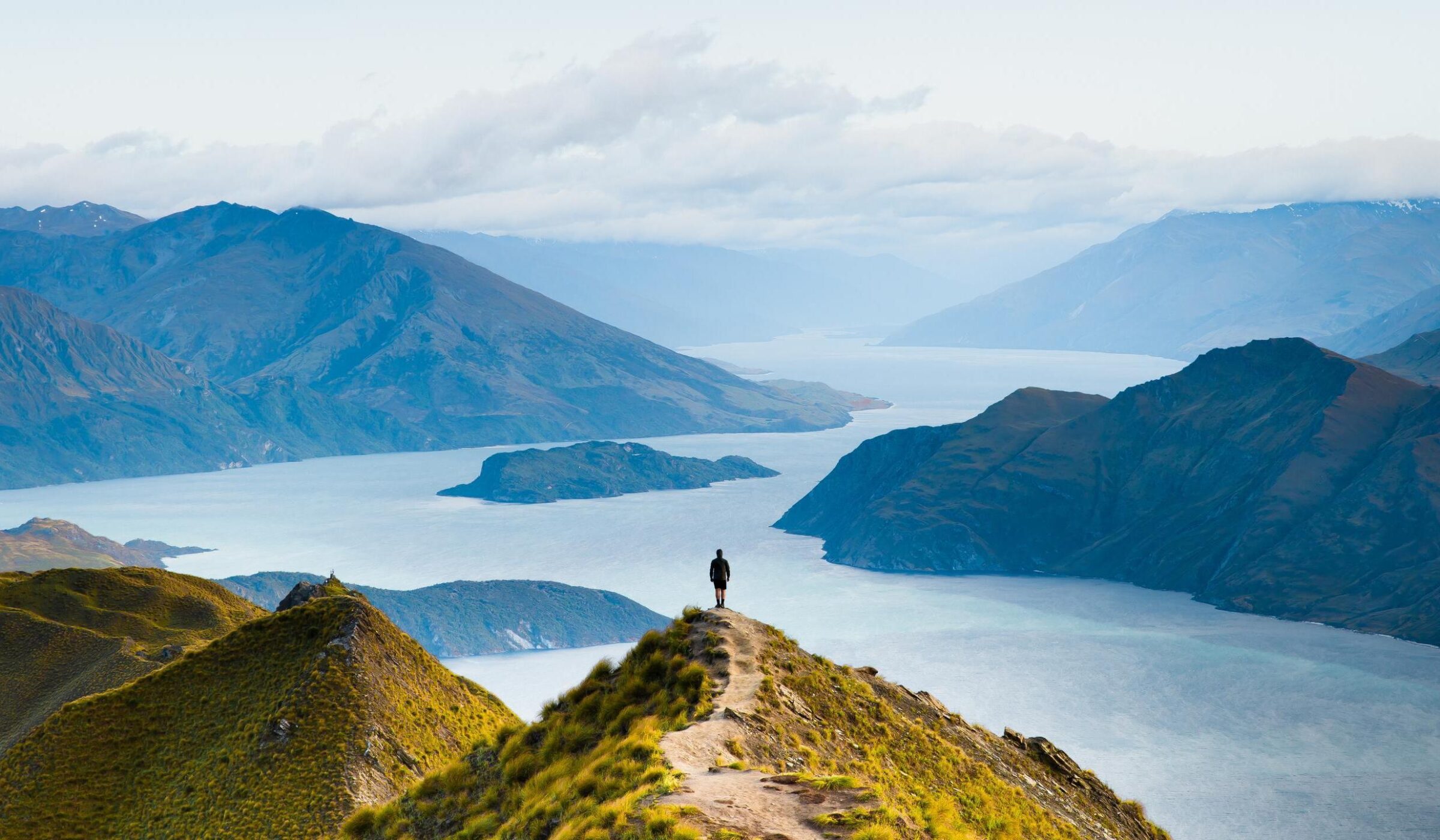 A man stood at the viewpoint from Roy's Peak in New Zealand