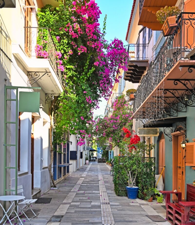 Narrow streets of Nafplion town with Bougainvillea flowers