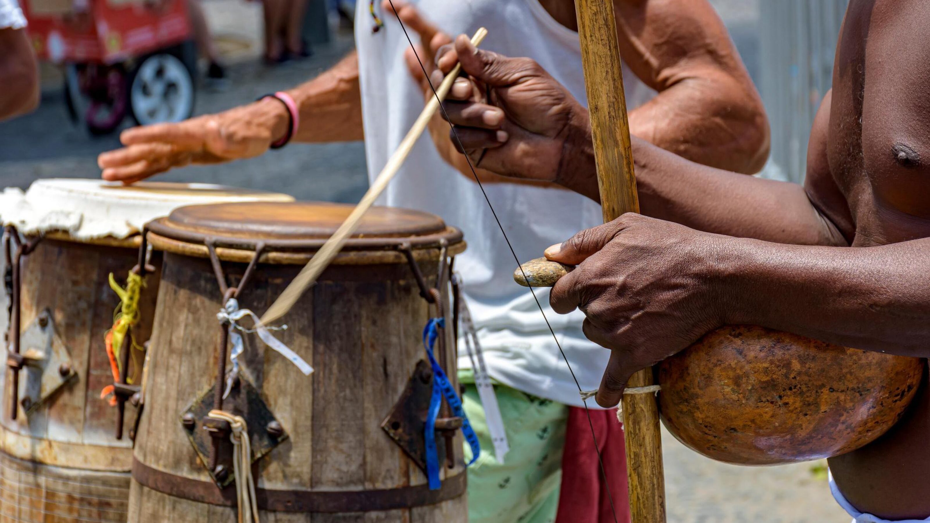 Men playing traditional musical instruments used in capoeira