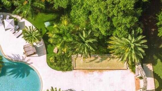 An areal view of modern pool and historic wall and archway at Chable Yucatan Resort & Spa