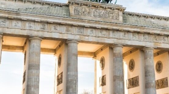 Neoclassical sandstone columns of Berlinx27;s Brandenburg Gate crowned by the Quadriga.