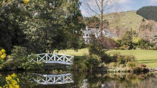 Otahuna Lodge set in beautiful gardens with lake and bridge