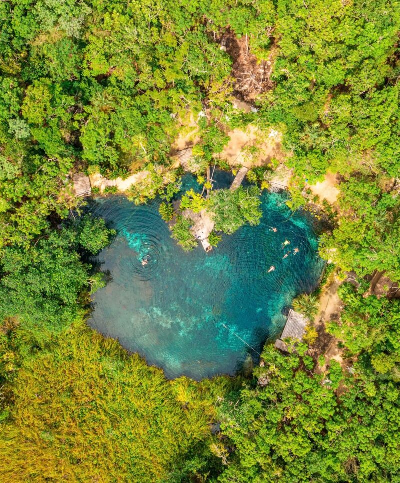 Heart shaped cenote in the middle of a jungle in Tulum, Mexico. Beautiful heart in nature. Romantic love style concept.
