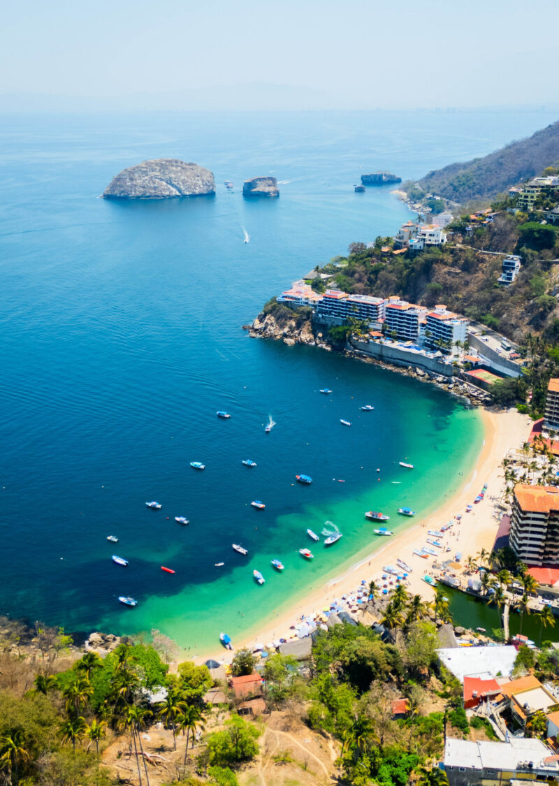 Drone shot of the majestic clear water beach, mismaloya beach and in the background the national marine park in puerto vallarta, mexico
