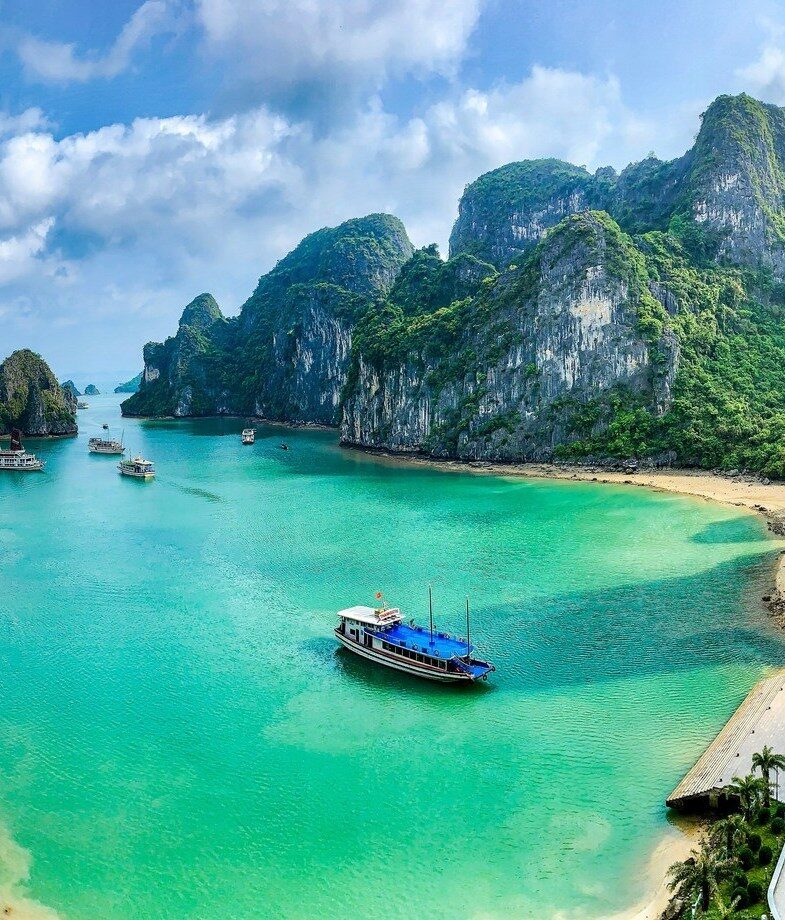 The blooming cherry blossoms along a historic canal in Kyoto, Japan, and the emerald waters and limestone karsts of Ha Long Bay in Vietnam.
