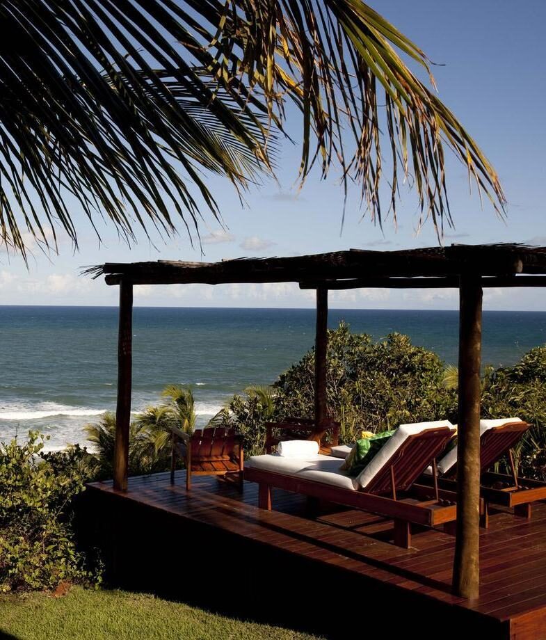 The open-plan living space at Casa Azul, one of the private villas at UXUA Maré in Trancoso, and the stunning ocean views from Txai Resort.