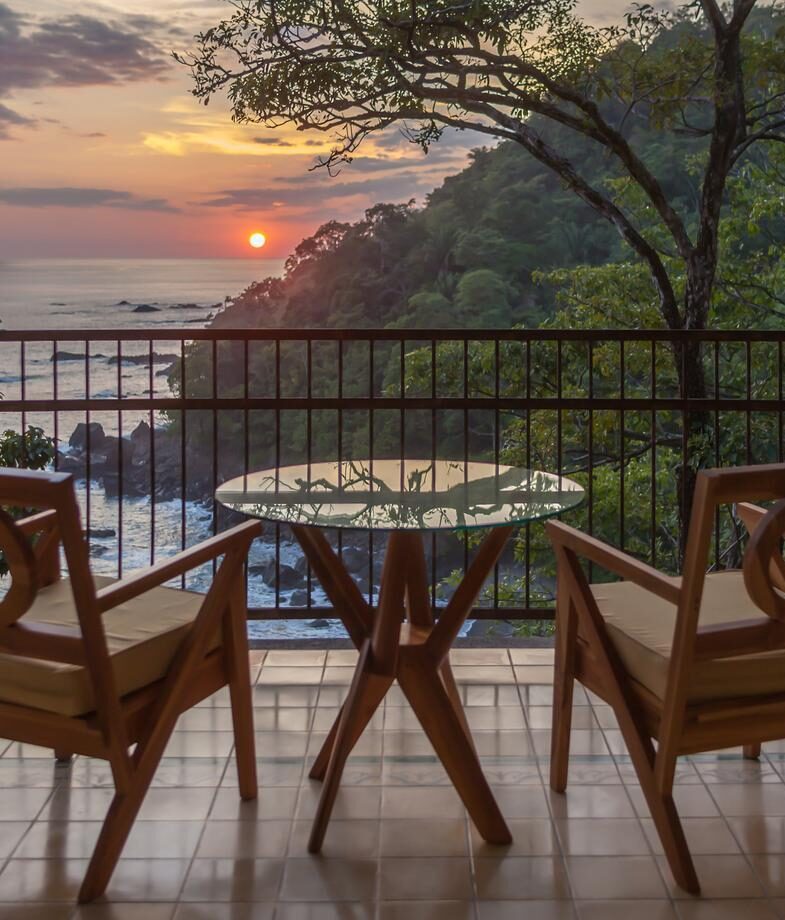 Rafting through the rainforest rapids of the Pacuare River and the ocean-view balcony at Arenas del Mar in Manuel Antonio at sunset.