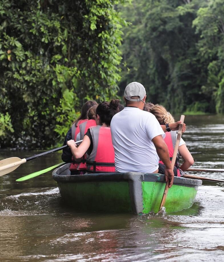 Kayaking through Tortuguero National Parkx27;s jungle canals and the main building and pool area at Playa Cativo Lodge on the Osa Peninsula.