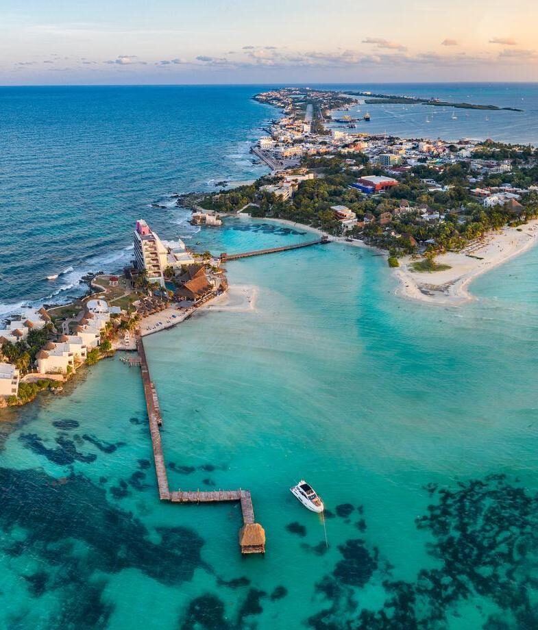 The dramatic rock formations of Land’s End at Playa del Amor during sunset and the aerial view of Isla Mujeres in Quintana Roo.
