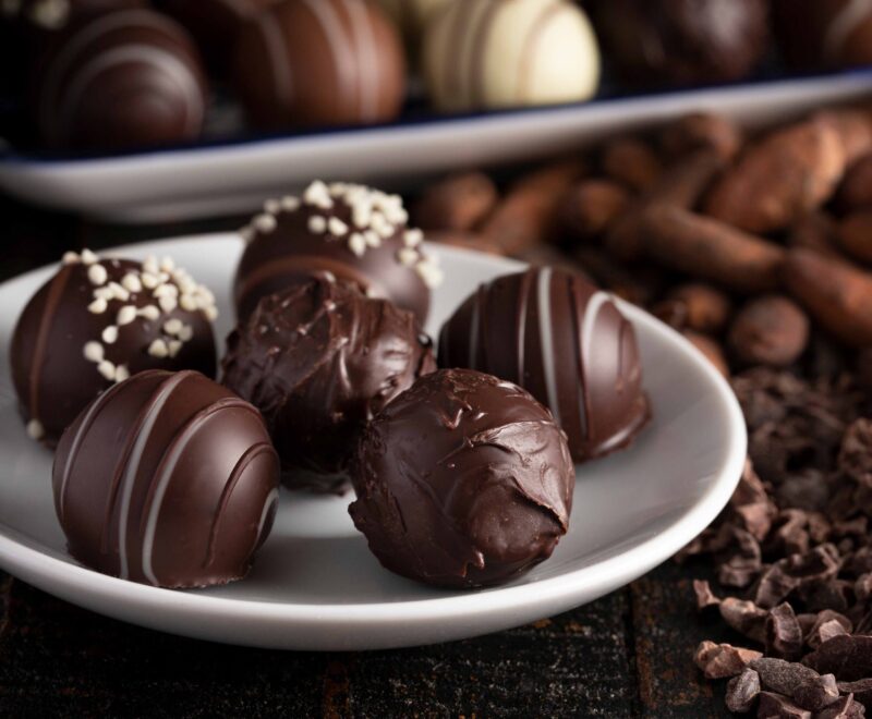 A Moody Image of Chocolate Truffles on a Rustic Wooden Table