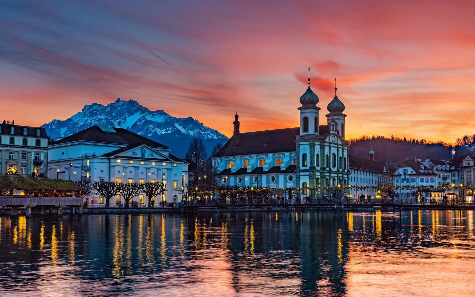 Splendid sunset over Lucerne with the snowy peaks of Mount Pilatus in the background.