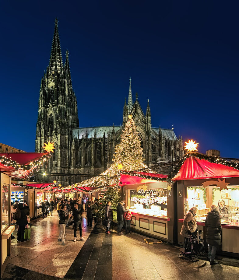 An aerial view of Salzburg’s festive celebrations, Austria, and the market in Cologne Cathedral’s square in Germany, both during Christmas.