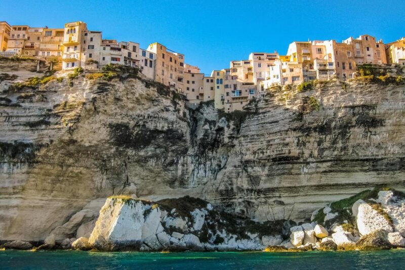 View of buildings above a steep cliff in Bonifacio, Corsica
