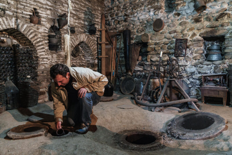 Nodari Wine Cellar Velistsikhe Georgia Sampling wine from underground vats