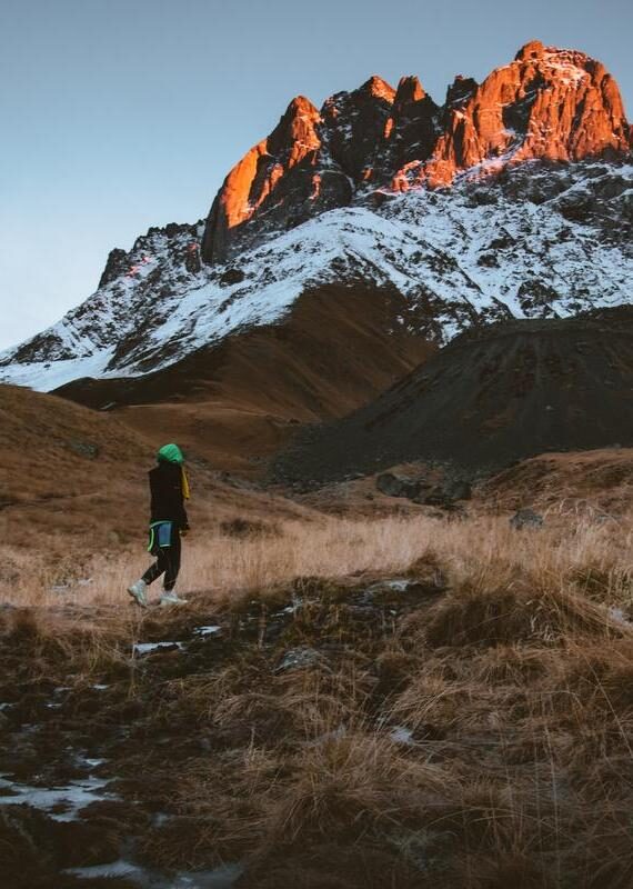 Female hiker hike trekking in beautiful Juta valley Kazbegi National Park Georgia