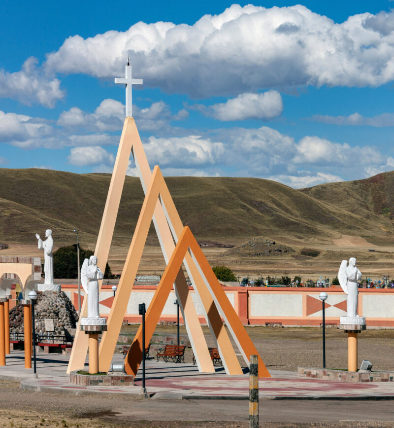 Modern religious monument at a cemetery high on the Altiplano in Peru, South America.