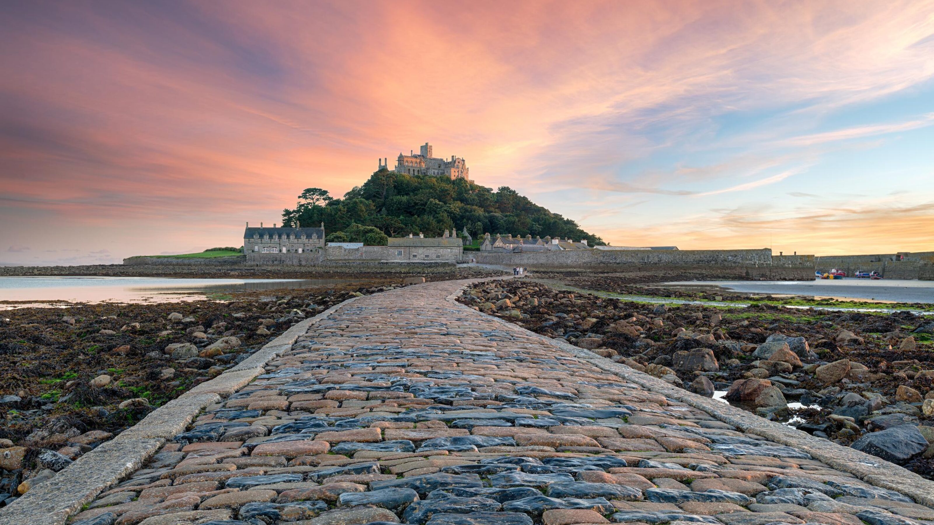 View of St Michael's Mount with close up of tidal path at sunset