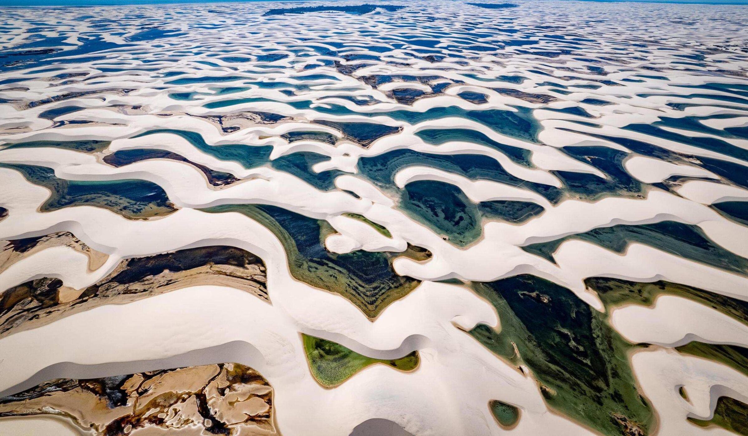 Aerial view of sand dunes and lagoons at Lençóis Maranhenses National Park