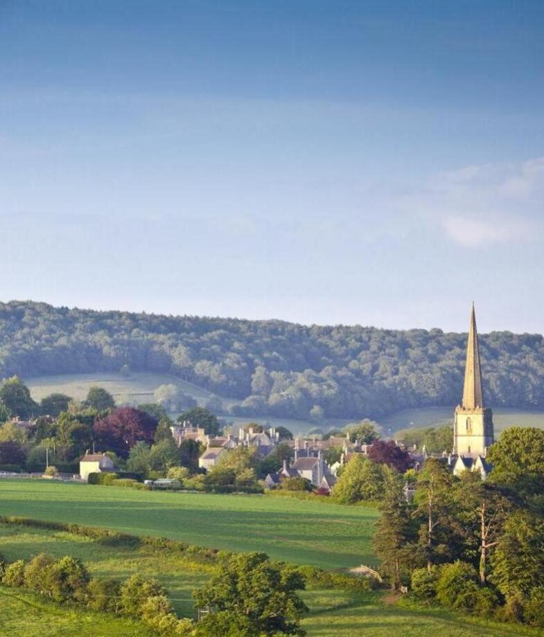 A narrow street leading to the ornate Basilica of Saint Mary in San Sebastián and rolling green hills dotted with stone villages across the Cotswolds.