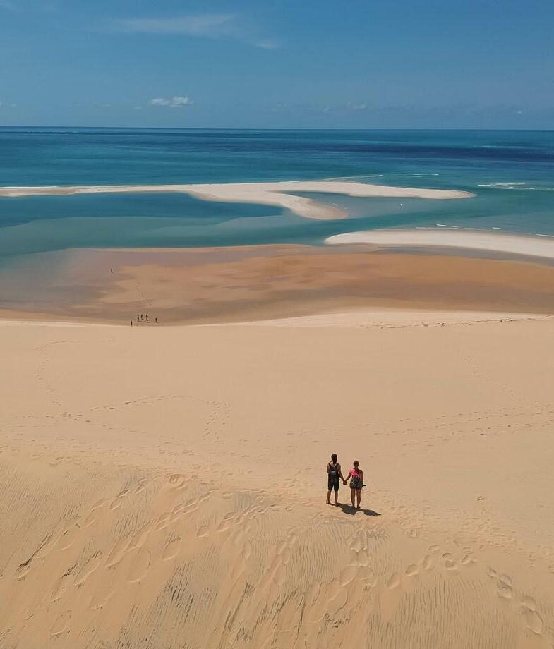 A caretaker feeding one of the young elephants at the Reteti Elephant Sanctuary and the endless sand dunes meeting turquoise waters in Bazaruto Archipelago.