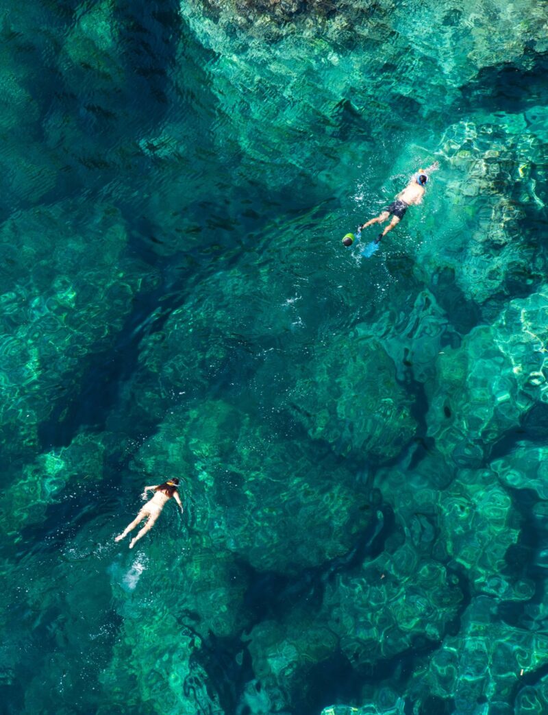 Drone view of a couple snorkeling in the sea