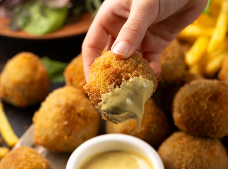 Fried Homemade beef Bitterballen with dijon mustard, ketchup and french fries