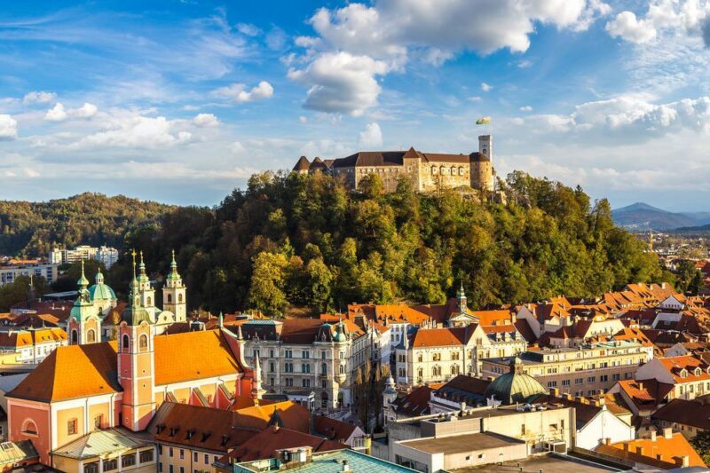 Aerial view of Ljubljana’s castle at sunset in Slovenia Aerial view of Ljubljana’s castle ljubljana, slovenia, europe, capital, castle, panorama, view, aerial, city, landscape, travel, medieval, church, romantic, old, colorful, architecture, outdoors, urban, scene, landmark, street, tower, historic, town, above, roof, sunset, sunrise, day, sun, light, cityscape, hill, center, panoramic, building, skyline, cloud, country, forest, european, slovenian, fortress, tourist, tourism, blue, summer, dusk, evening