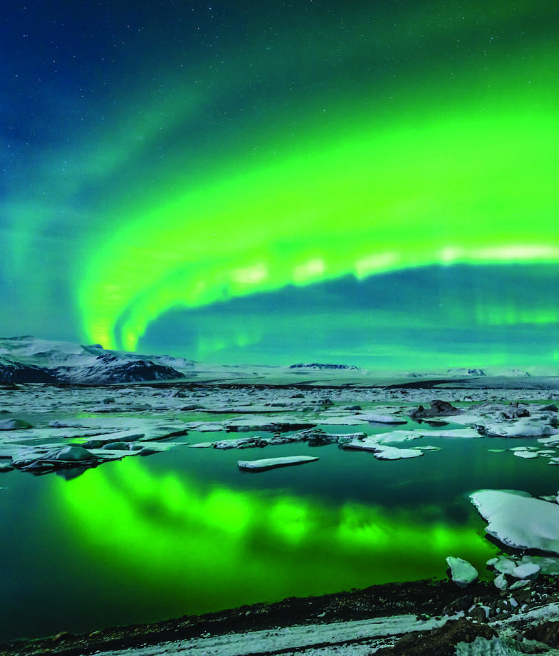 The glowing northern lights shimmering over Iceland’s frozen lakes and the snow-covered Neuschwanstein Castle nestled in Bavaria’s Alps, Germany.