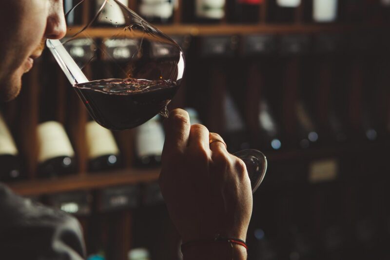 Luxury European Tours - A red wine tasting with a wine cellar in the background