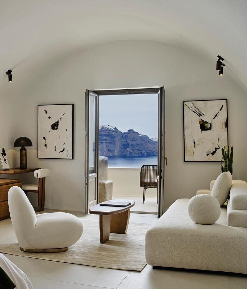 The sleek white suites of Andronis Concept in Greece opening onto sweeping caldera views, and the rolling hills and green expansive vineyards surrounding Six Senses Douro Valley in Portugal.