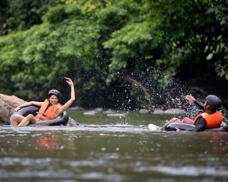 Two people tubing along the Danum River in Borneo's Danum Valley.