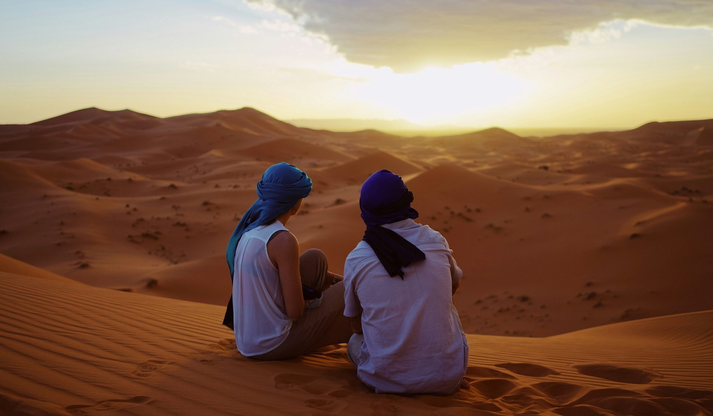 Couple in the Moroccan Sahara during sunset