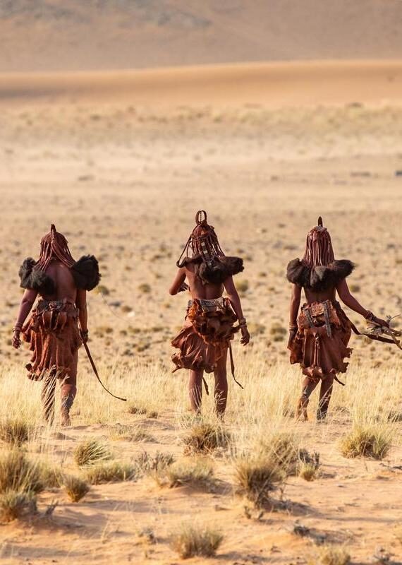 A group of Himba women walking through the desert in Namibia.