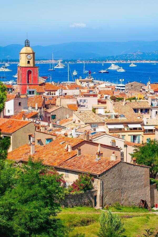 Aerial view of old town of St Tropez. Houses with red roofs and church along the coastline and harbor on the French Riviera. Cruise ship destination. 1014764382 saint, st, tropez, view, alps, scenic