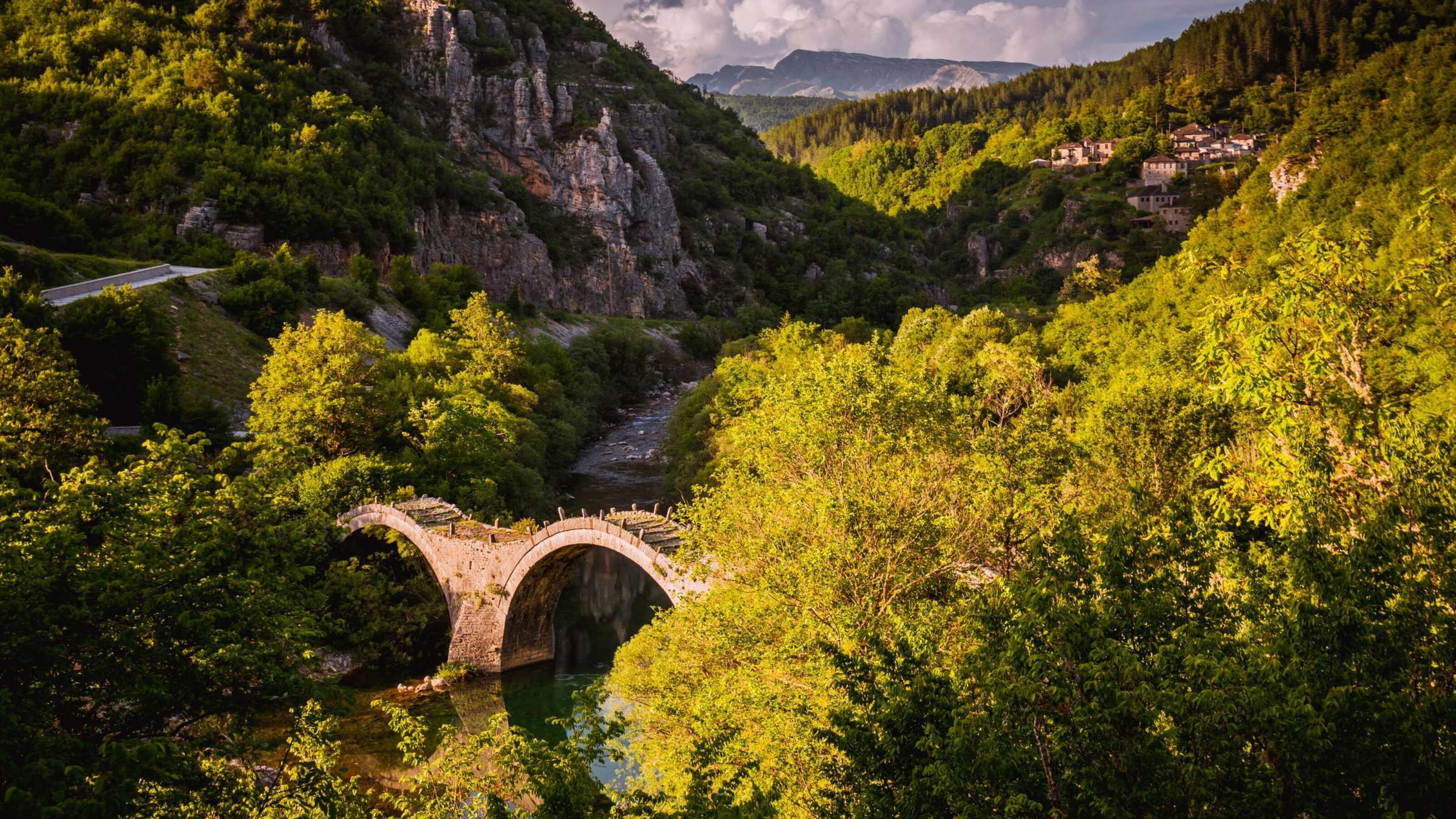 The arched Plakidas Bridge over the Voidomatis river in Zagoria, Greece