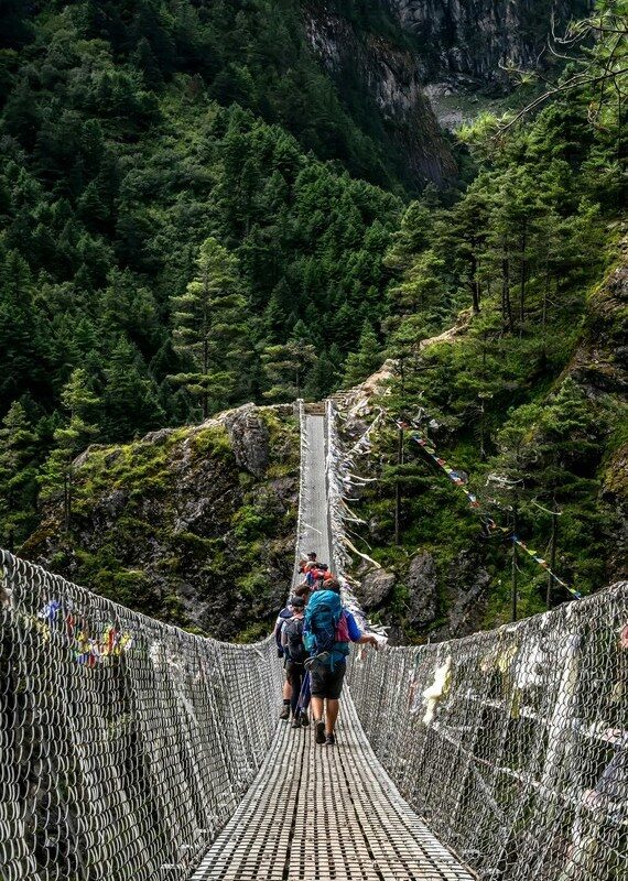 hiking family experience in Nepal crossing one of its hanging bridges