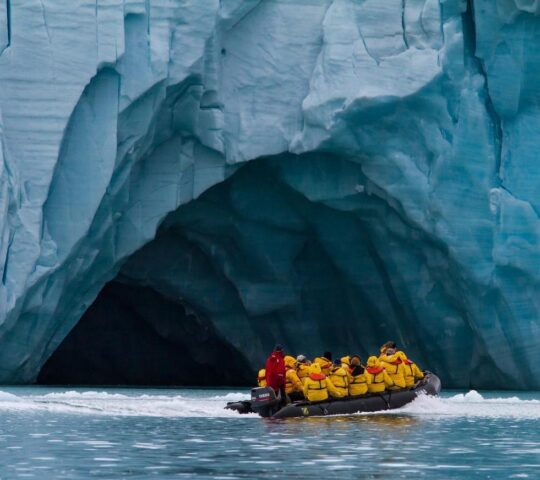 Cruise past towering icebergs and ice cliffs on Zodiac excursions