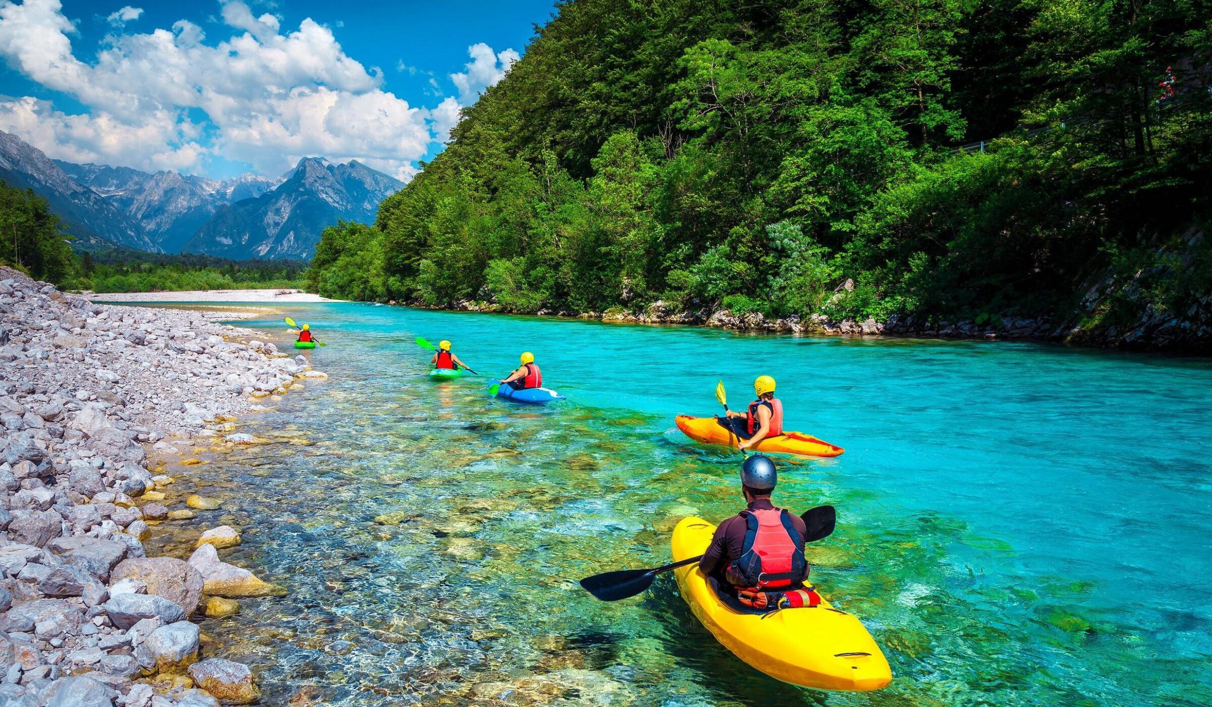 Sporty kayakers on the beautiful turquoise Soca river
