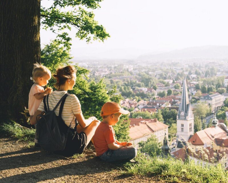 Family trip sitting enjoying panoramic views of Ljubljana, Slovenia
