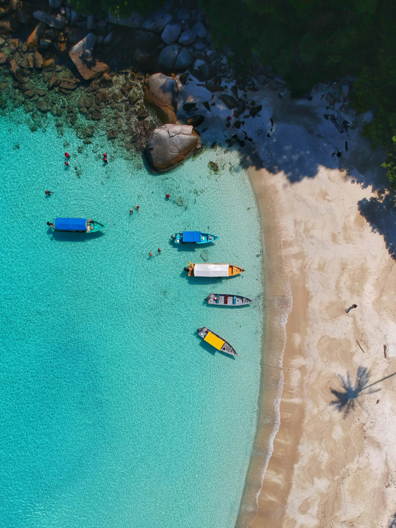 Traditional fishing boats on a secluded golden beach in Southern Sri Lanka, part of a bespoke luxury coastal escape.
