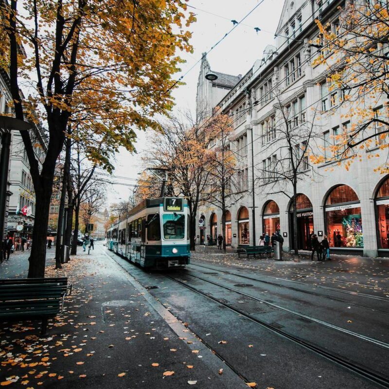 Switzerland city tour with the tam passing during autumn