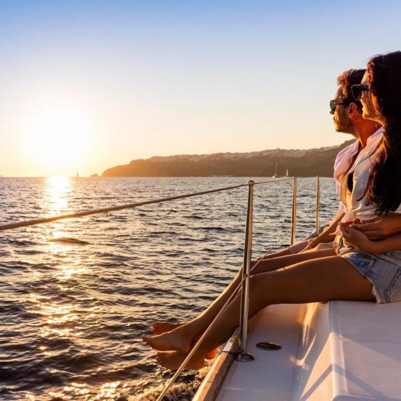 Couple at sunset Santorini, adventure, attractive, boat, caucasian, couple, cruise, cruising, dusk, freedom, greece, happiness, happy, holiday, honeymoon, love, luxury, man, ocean, people, romantic, sail, sailboat, sailing, sea, summer, sunset, travel, trip, vacation, wealth, woman, yacht, yachting, young Romantic couple on yacht at sunset
