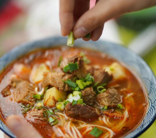 Taste a Thai noodle soup, finished with herbs, lime and chilli at the table
