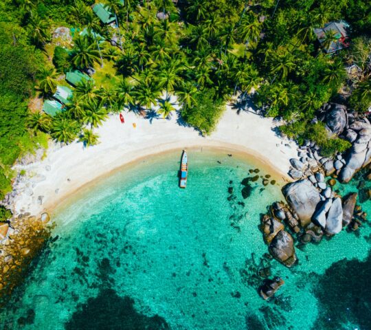 Unwind on a palm-fringed bay only reachable by boat, with time to swim in clear water and relax on the sand
