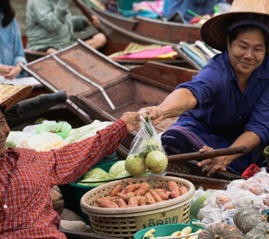 Drift through the floating market by longtail boat and see how everyday life unfolds on the water